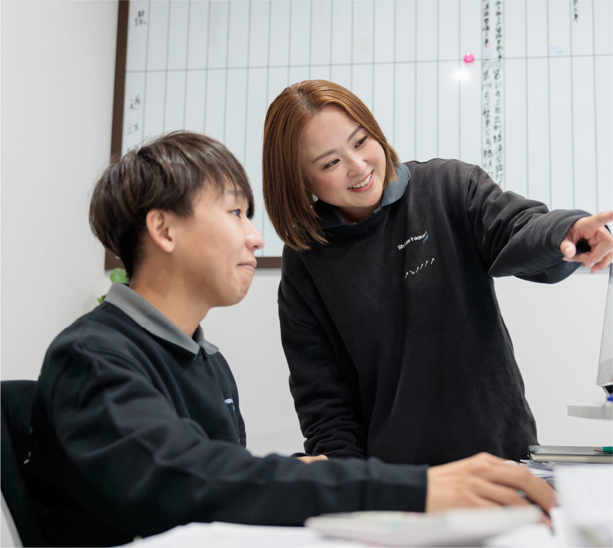 デスクの上で電卓を使いながら資料を確認し、計算作業を行っている様子